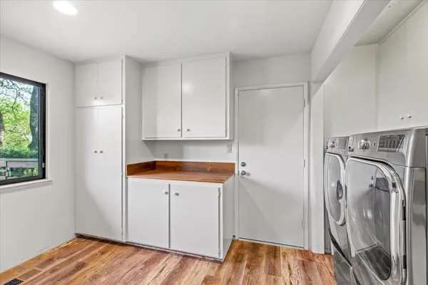 a view of a room with a ceiling fan and a window