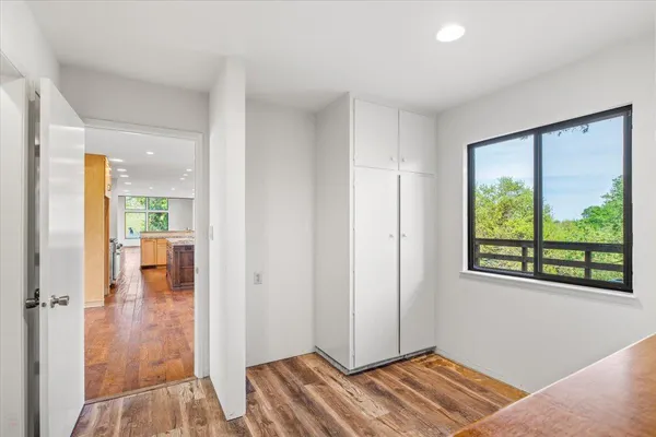 a large white kitchen with a sink and cabinets