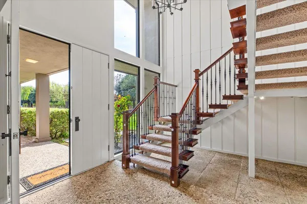 a view of a balcony with furniture and a rug