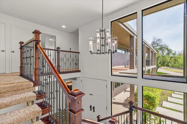 a view of a balcony with chairs and wooden floor