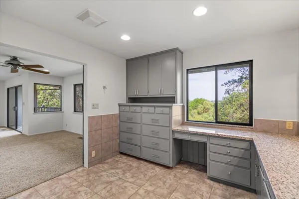 an aerial view of a golf course with huge green field and covered with green space
