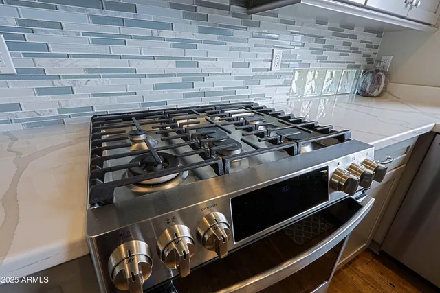 a kitchen with stainless steel appliances granite countertop a refrigerator and a sink
