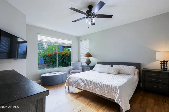 a bedroom with a bed and ceiling fan