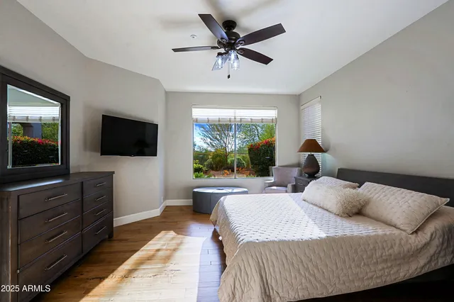 a bathroom with a granite countertop toilet sink and mirror