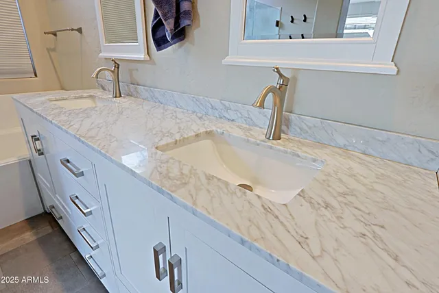 a view of a patio with table and chairs and potted plants