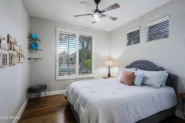 a bedroom with a bed and a mirror