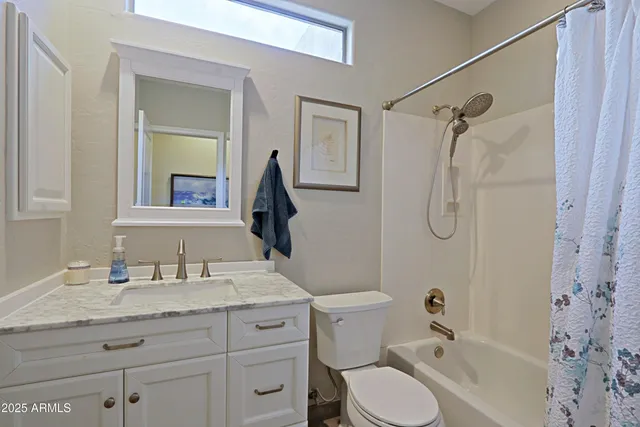 an aerial view of residential houses with cars parked on the road