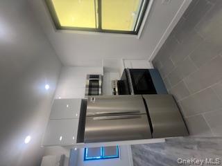 30-32 33rd Street Queens, NY 11102 - Photo 3 of 5 a kitchen with stainless steel appliances a refrigerator and a stove top oven