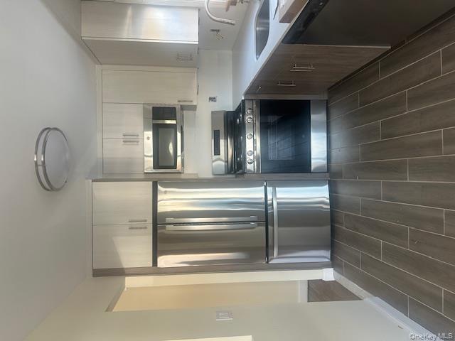 30-32 33rd Street Queens, NY 11102 - Photo 4 of 5 a kitchen with stainless steel appliances a refrigerator sink and microwave