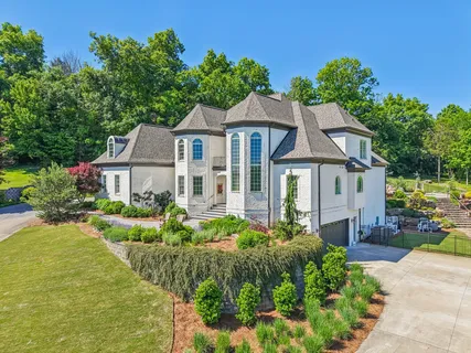 a front view of a house with a yard and a garden
