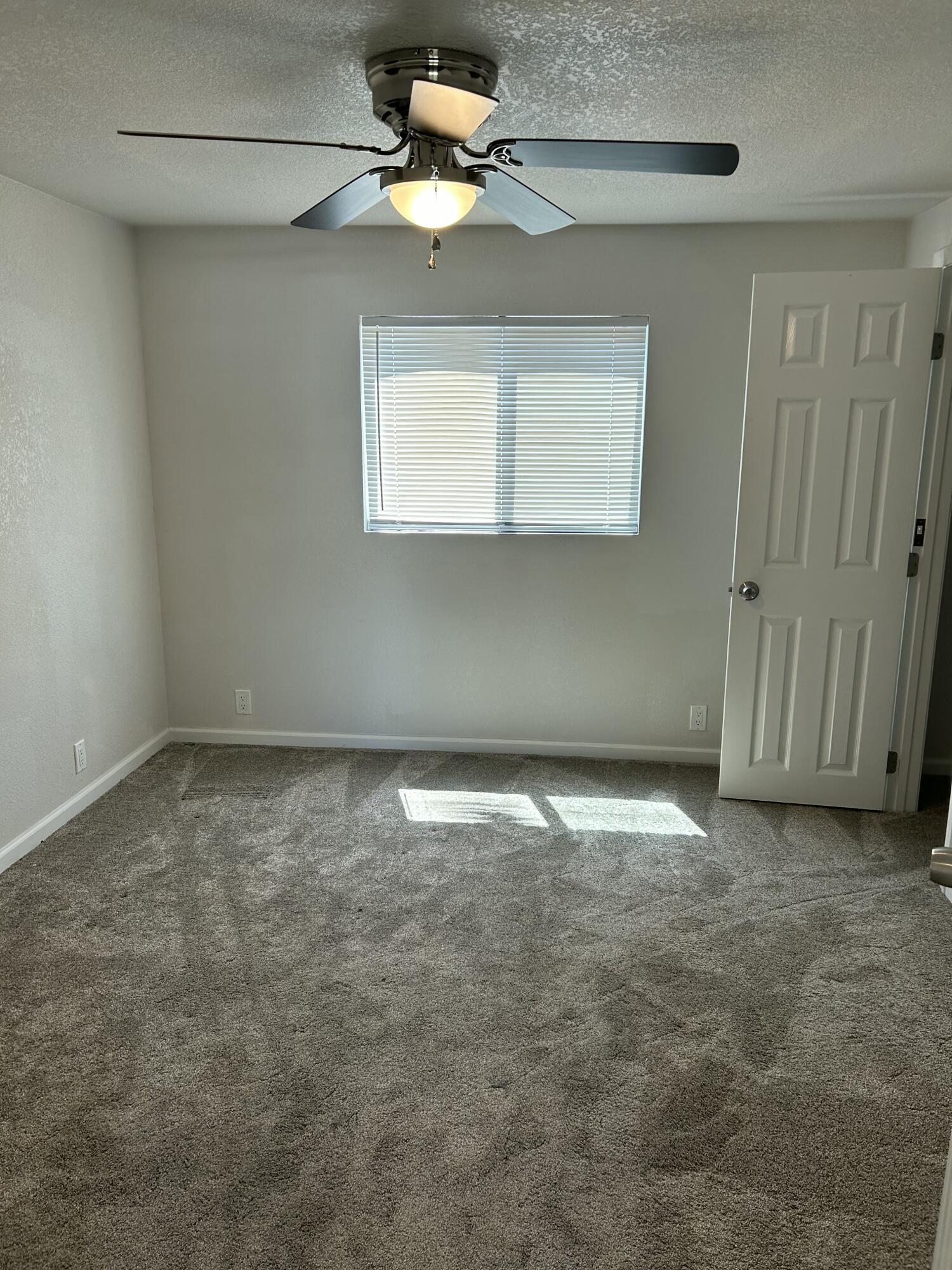 2339 North Drive Redding, CA 96001 - Photo 11 of 18 a view of empty room with ceiling fan and window