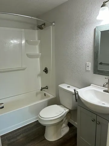 a bathroom with a toilet a sink and bathtub