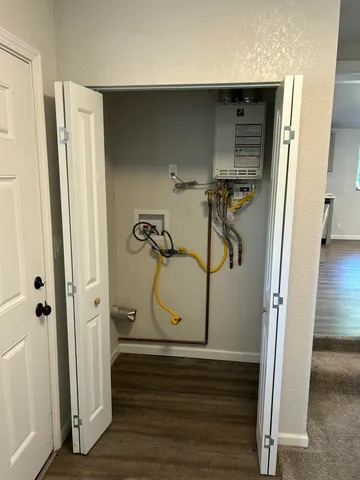 a view of a room with wooden floor and white walls