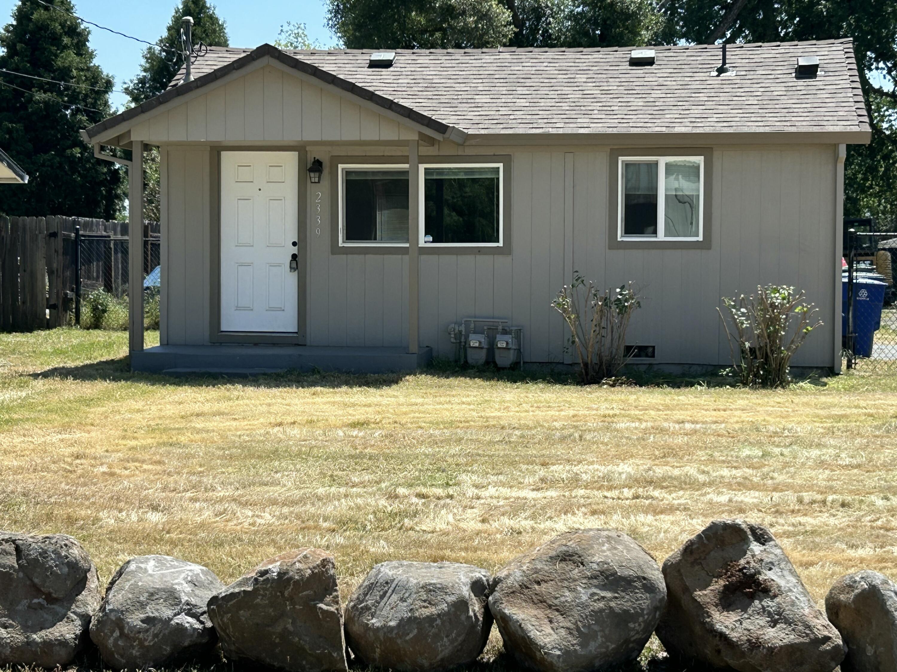 2339 North Drive Redding, CA 96001 - Photo 2 of 18 a view of a house with a swimming pool and a chair