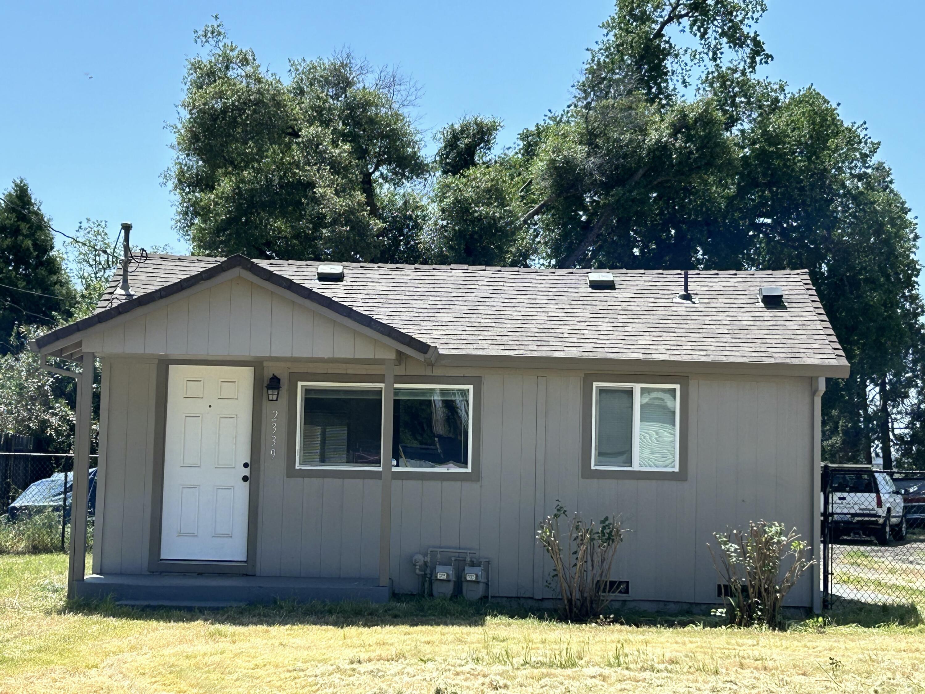 2339 North Drive Redding, CA 96001 - Photo 3 of 18 a view of a house with a yard covered with snow in front of it