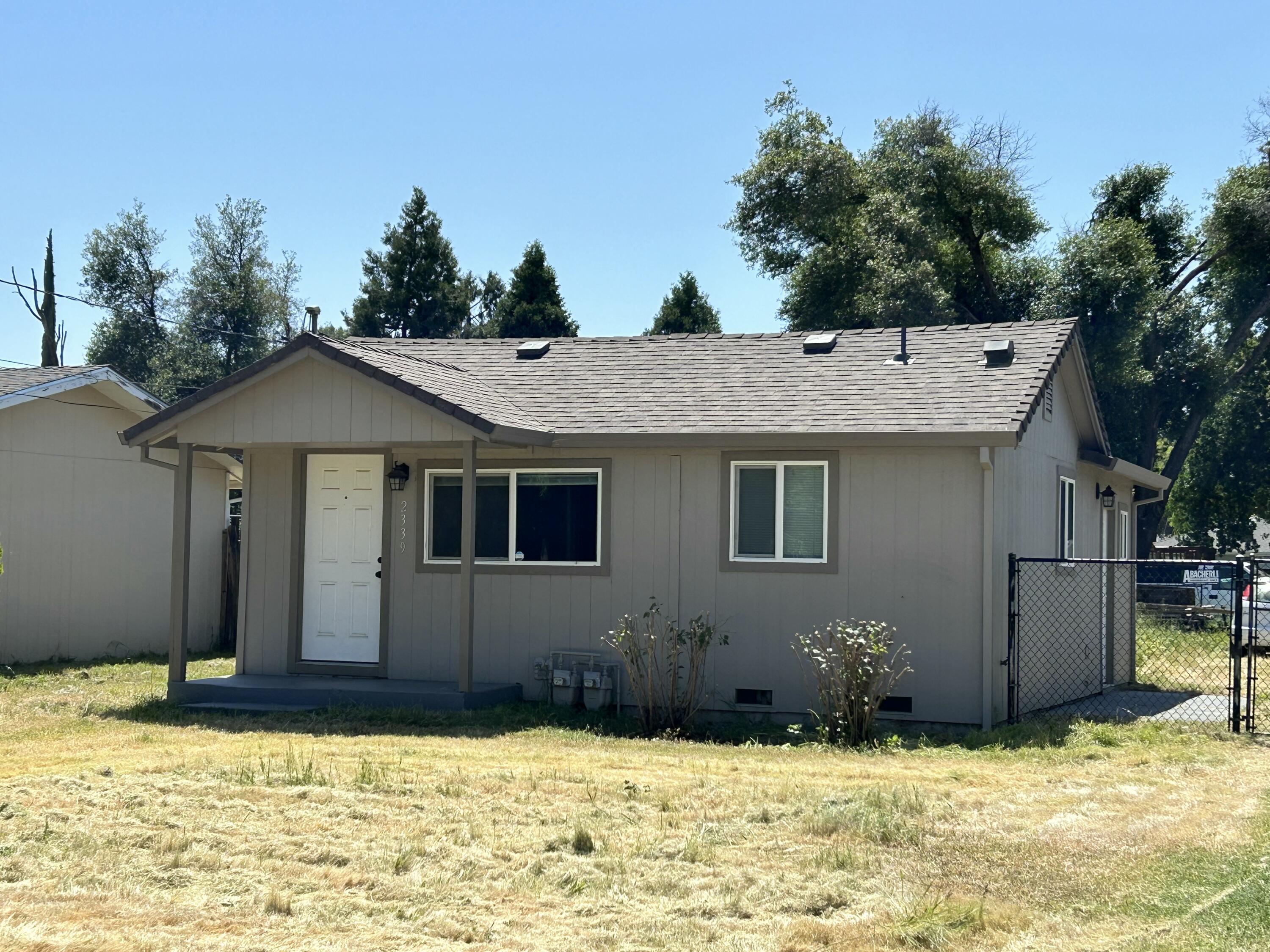 2339 North Drive Redding, CA 96001 - Photo 4 of 18 a view of a house with a yard covered with snow in front of it