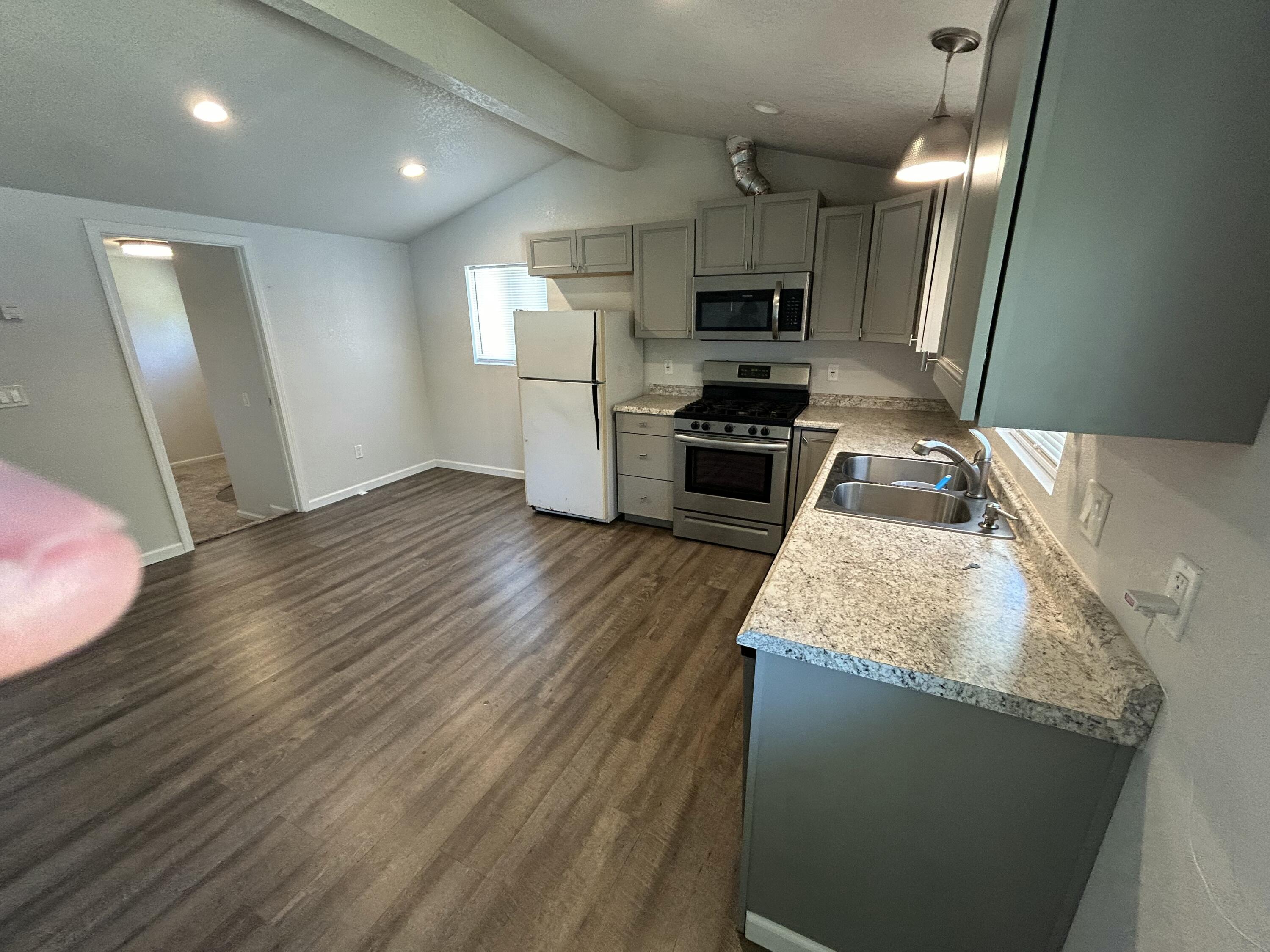2339 North Drive Redding, CA 96001 - Photo 9 of 18 a kitchen with granite countertop a sink stainless steel appliances and counter space