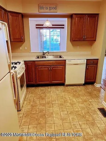 a kitchen with a refrigerator and a stove