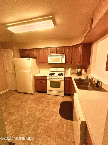 a kitchen with a cabinets a sink and a stove