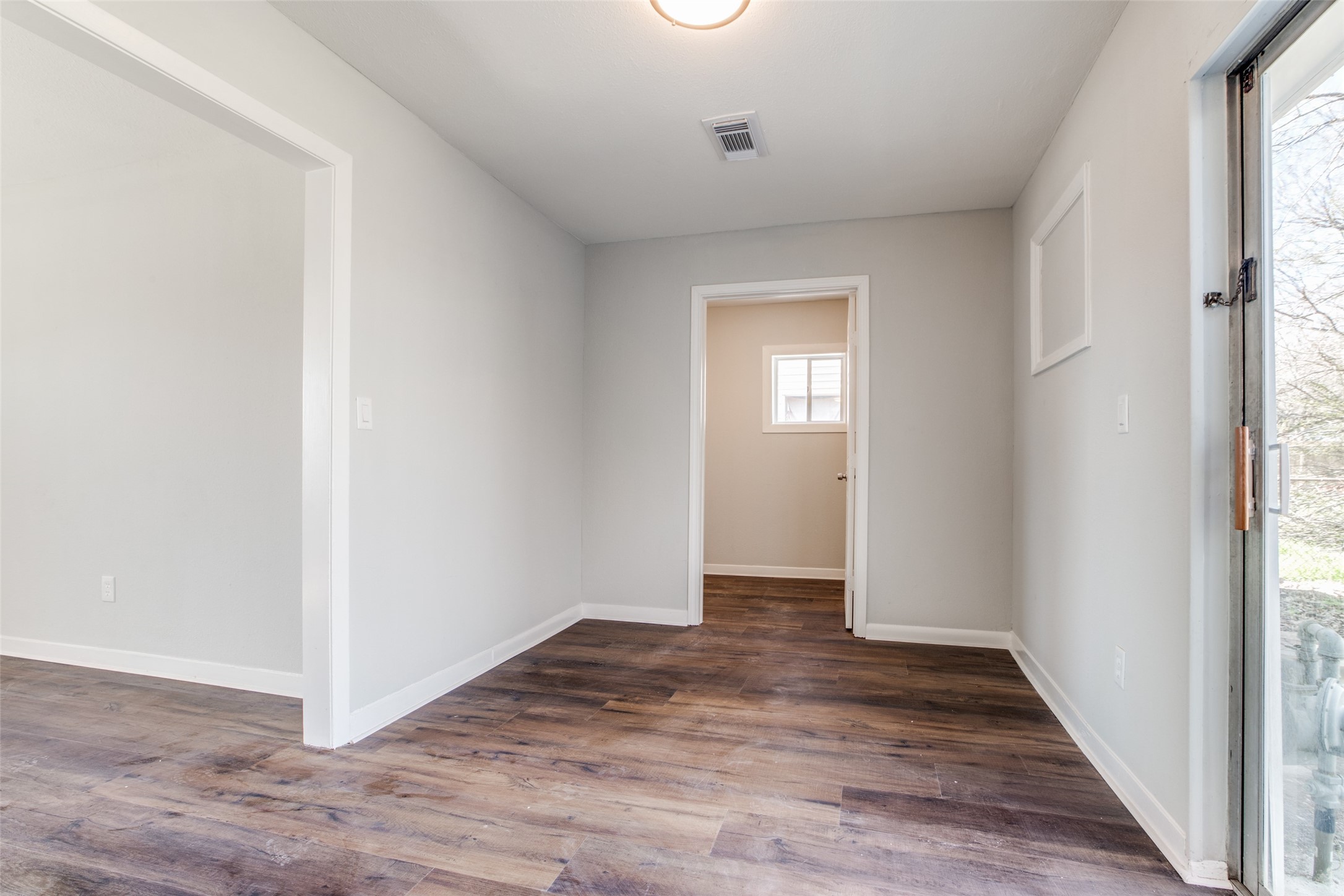 8615 Josie Street Houston, TX 77029 - Photo 16 of 25 an empty room with wooden floor and windows