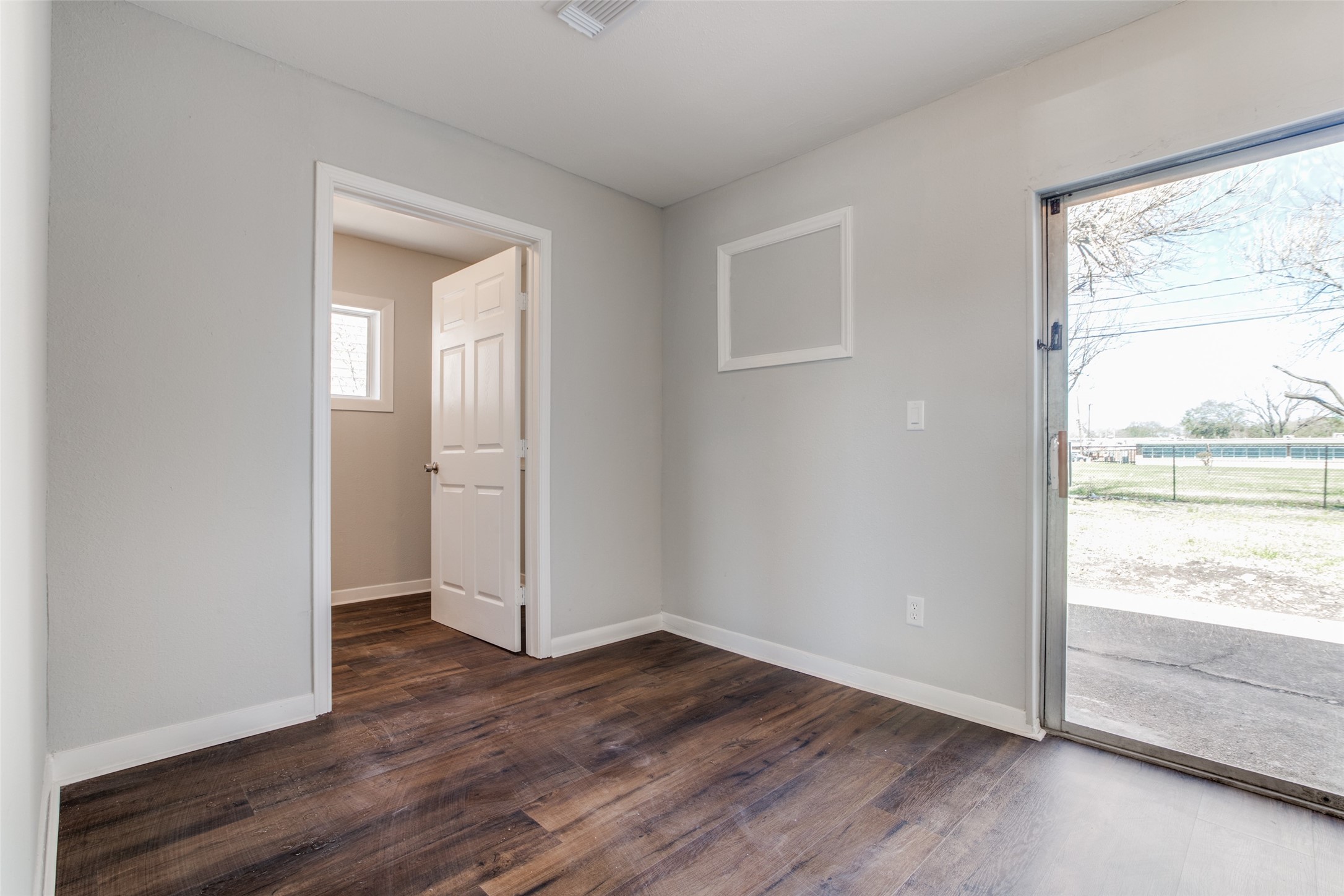 8615 Josie Street Houston, TX 77029 - Photo 17 of 25 an empty room with wooden floor and windows
