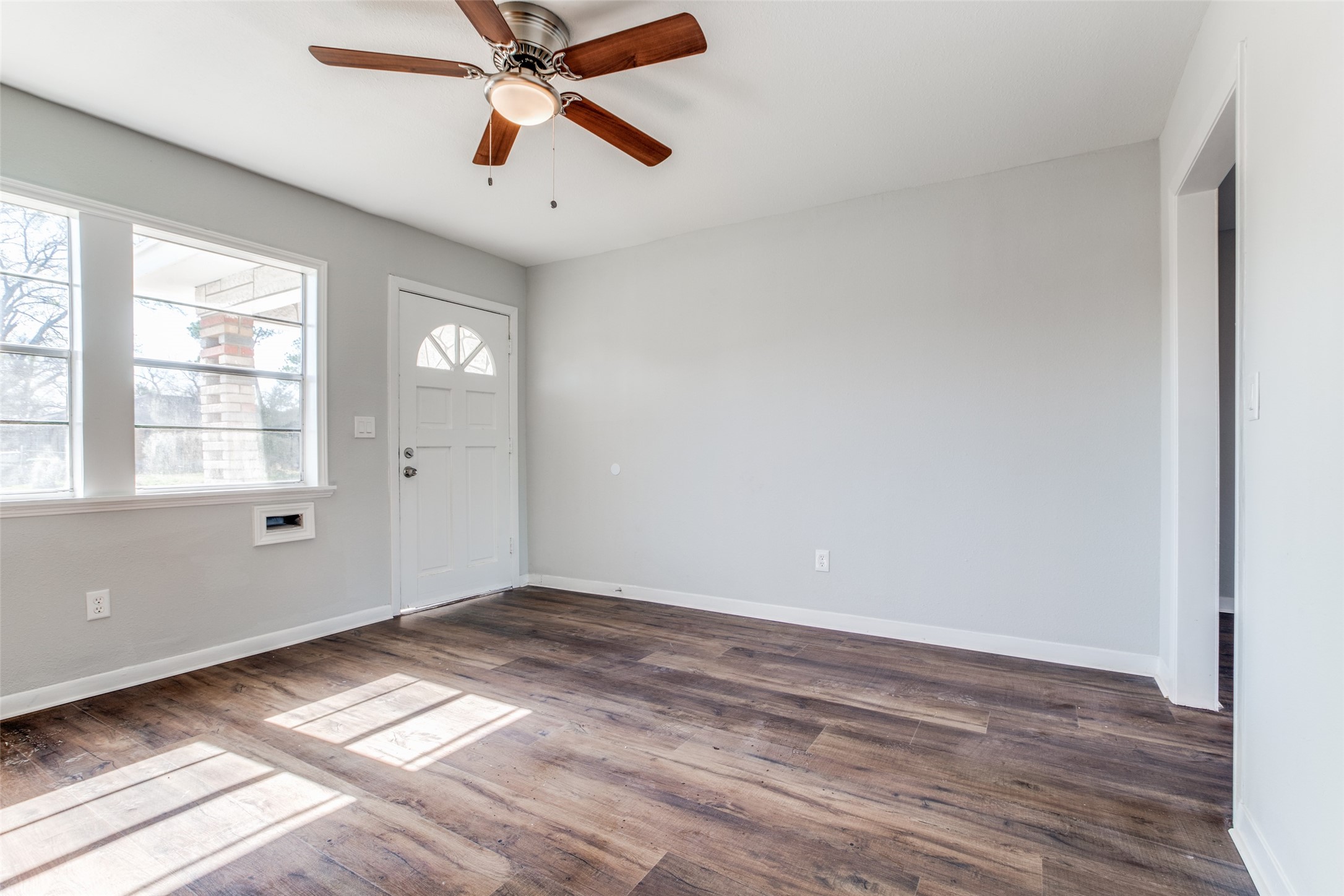 8615 Josie Street Houston, TX 77029 - Photo 5 of 25 a view of empty room with wooden floor and fan