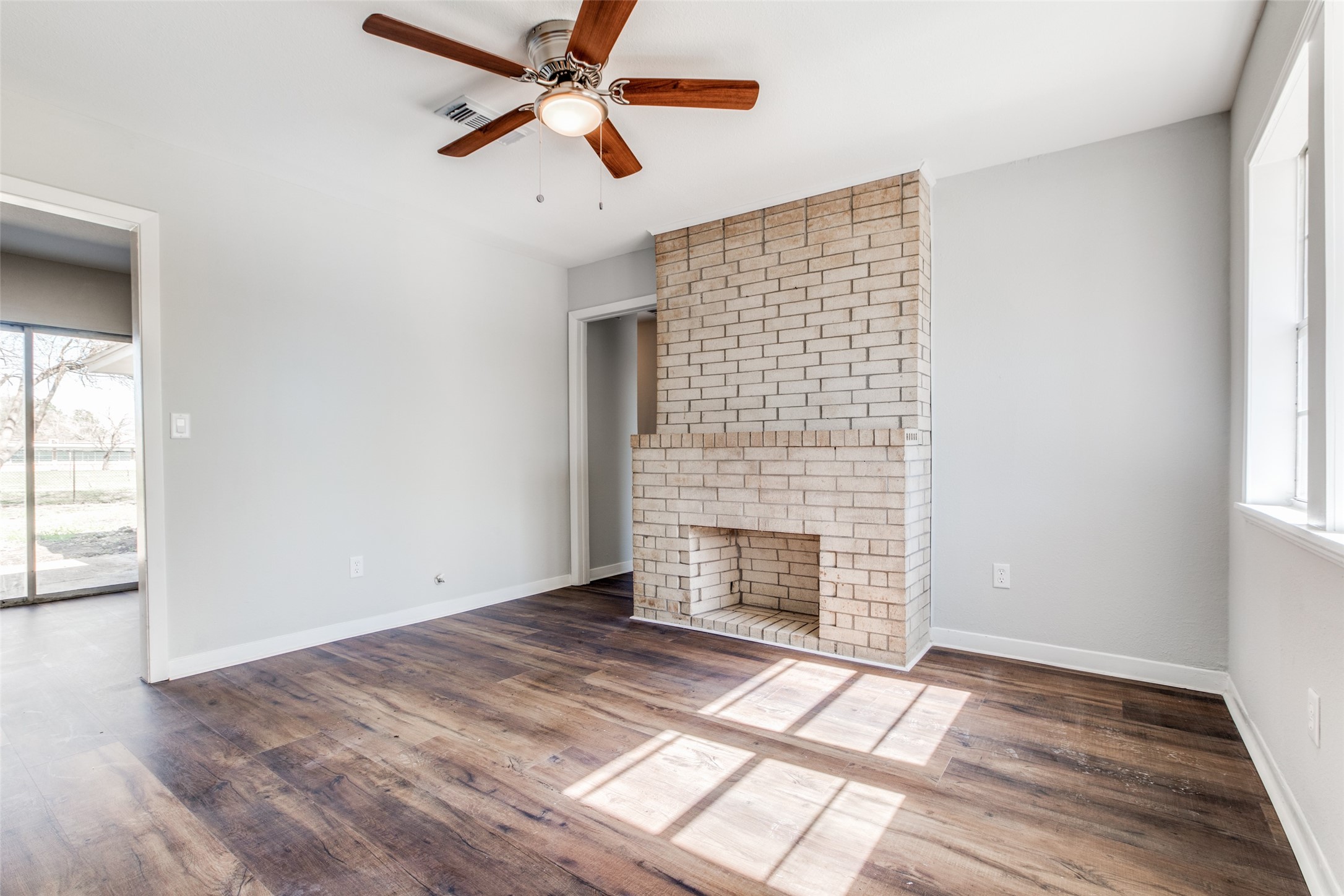 8615 Josie Street Houston, TX 77029 - Photo 7 of 25 an empty room with windows and fireplace