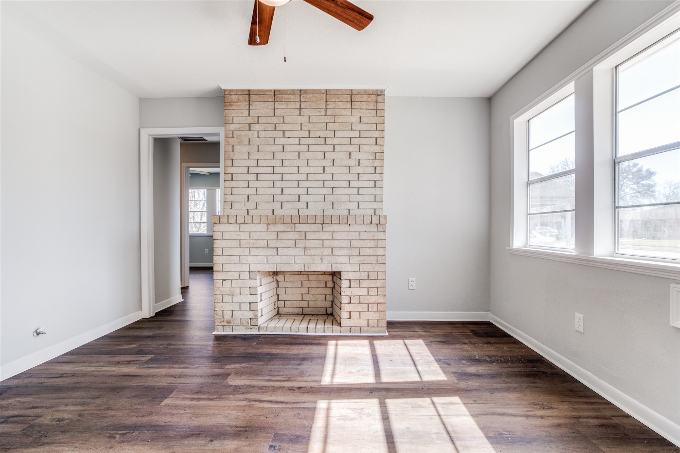 8615 Josie Street Houston, TX 77029 - Photo 8 of 25 an empty room with windows and fireplace