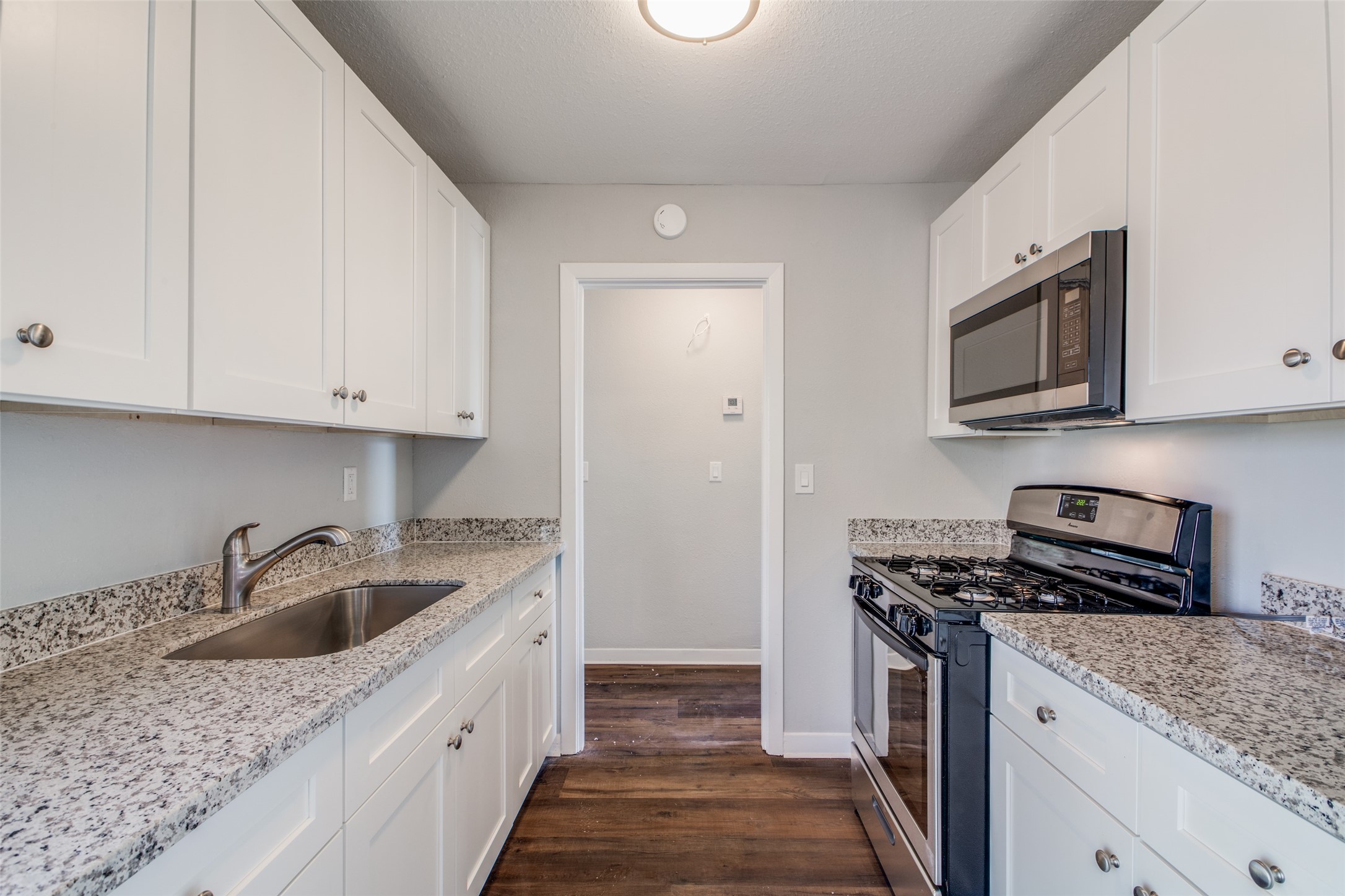 8615 Josie Street Houston, TX 77029 - Photo 9 of 25 a kitchen with stainless steel appliances granite countertop a sink stove and microwave