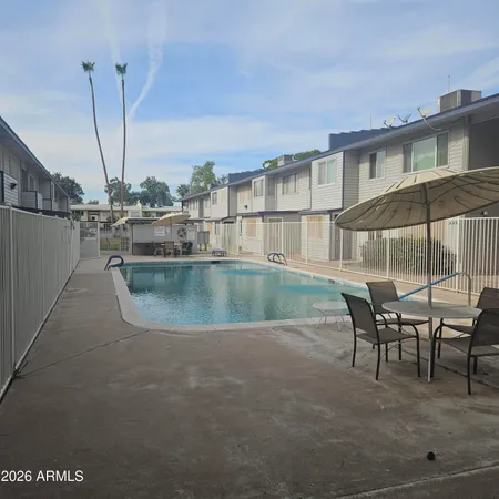 a view of a swimming pool with outdoor seating
