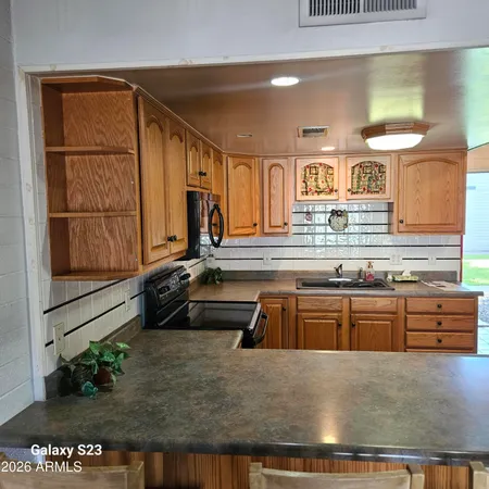 a kitchen with stainless steel appliances granite countertop a sink and a stove
