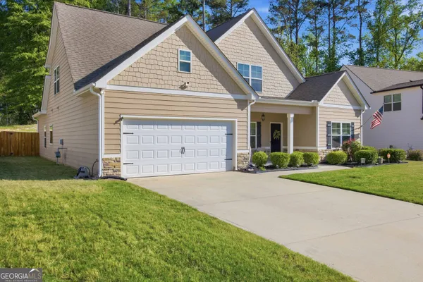 a front view of a house with a yard and garage