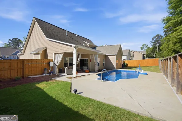 a view of a patio with swimming pool table and chairs