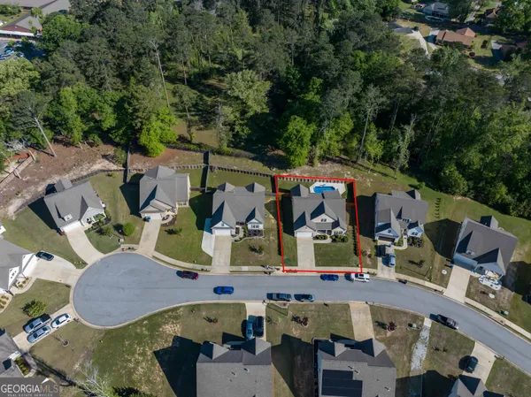 an aerial view of houses with outdoor space