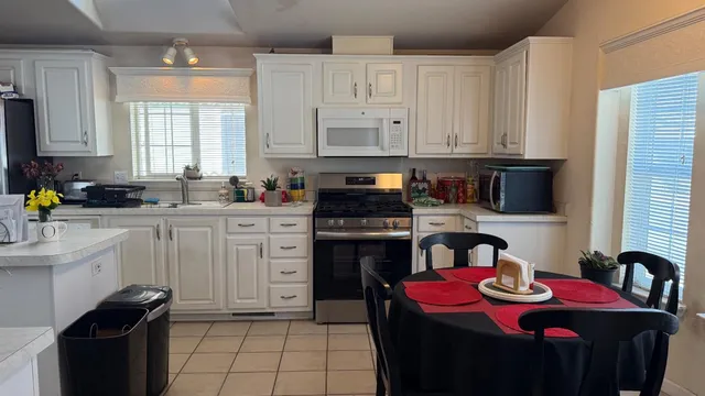 a kitchen with stainless steel appliances granite countertop a sink stove and cabinets