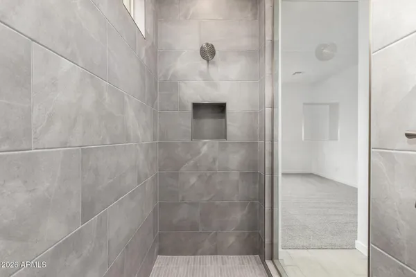 a bathroom that has a glass shower door