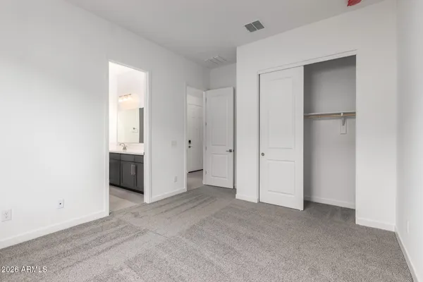 a view of an empty room and closet area