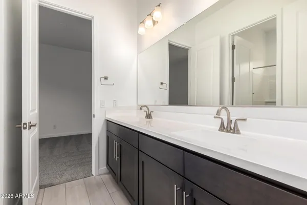 a view of an empty room with closet and a bathroom