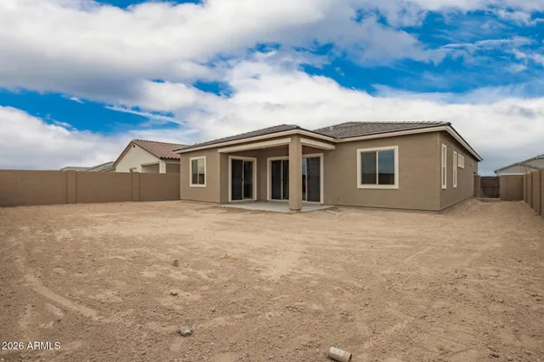 a view of house with backyard and parking area