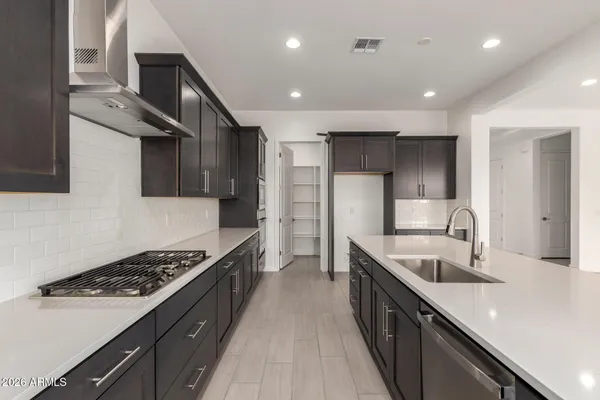 a kitchen with stainless steel appliances a stove sink and cabinets