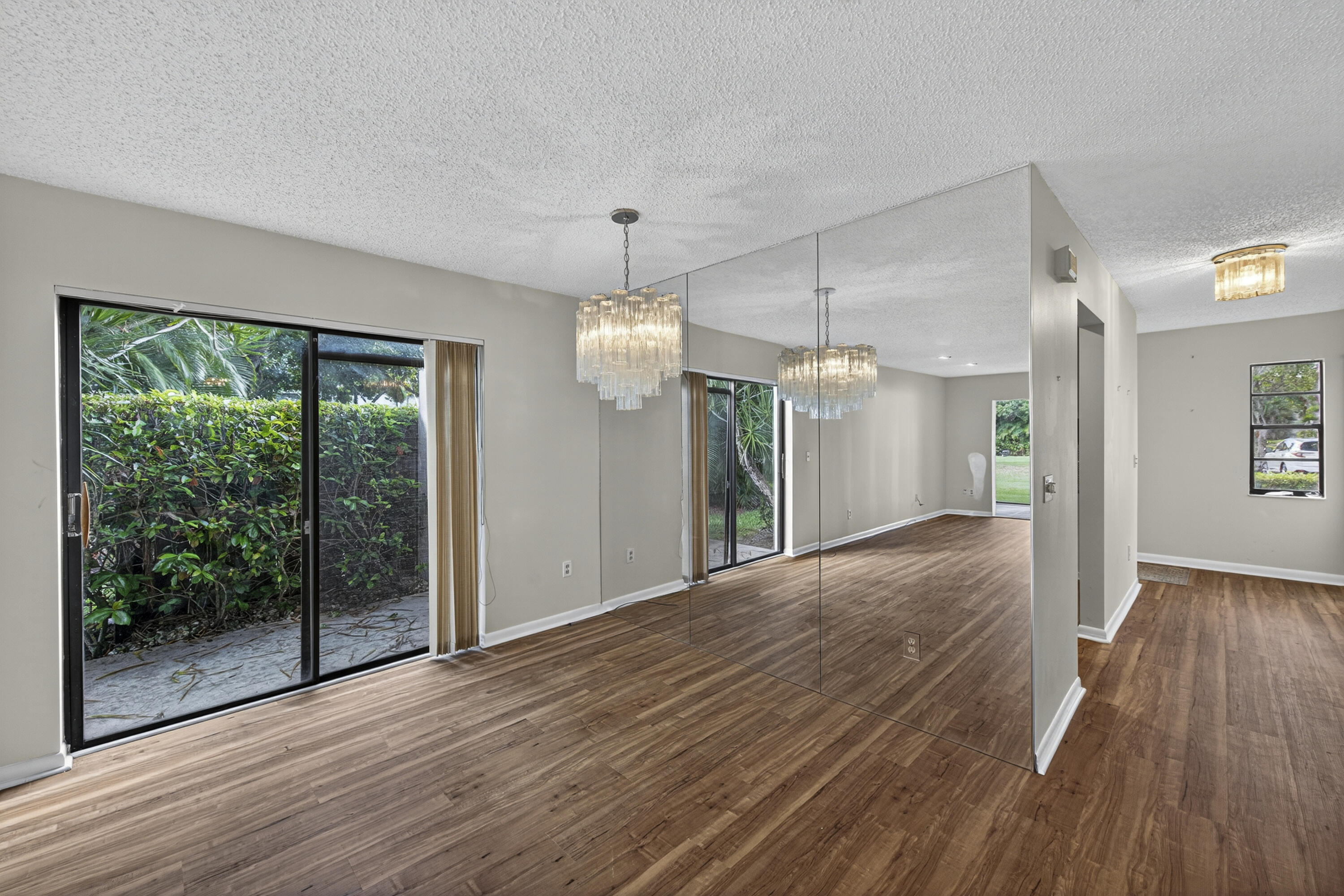 9187 Norte Lago, Unit 5I Boca Raton, FL 33428 - Photo 17 of 37 an empty room with wooden floor and windows