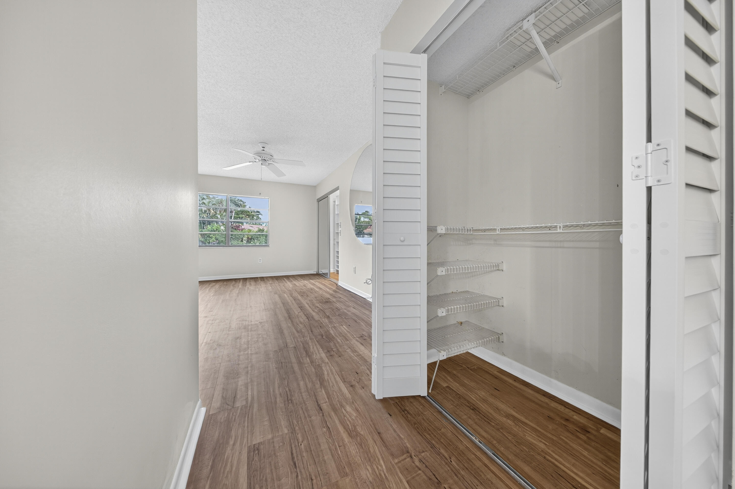 9187 Norte Lago, Unit 5I Boca Raton, FL 33428 - Photo 21 of 37 a view of hallway with wooden floor