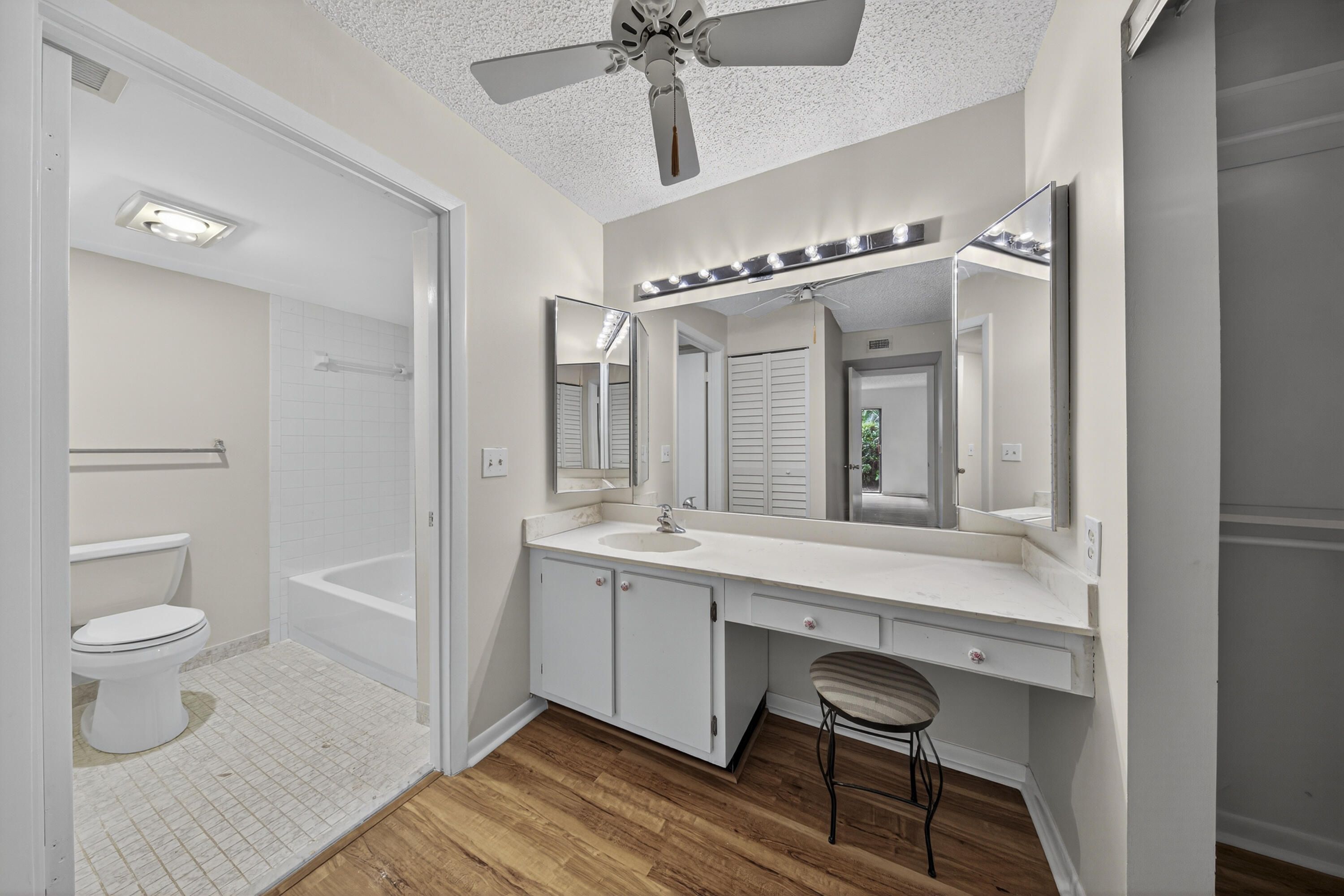 9187 Norte Lago, Unit 5I Boca Raton, FL 33428 - Photo 22 of 37 a spacious bathroom with a toilet a sink and a mirror