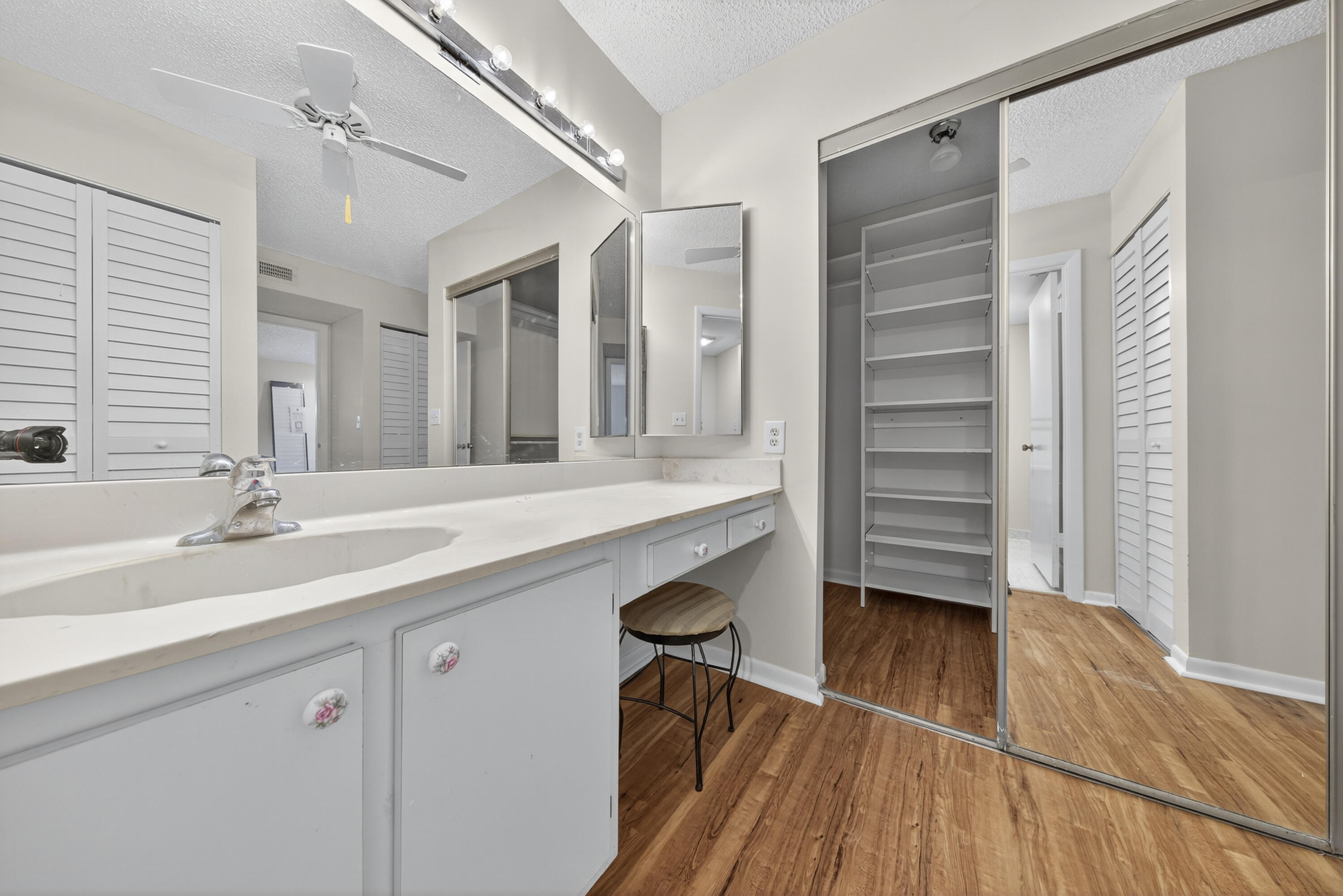 9187 Norte Lago, Unit 5I Boca Raton, FL 33428 - Photo 23 of 37 a bathroom with a sink and a mirror