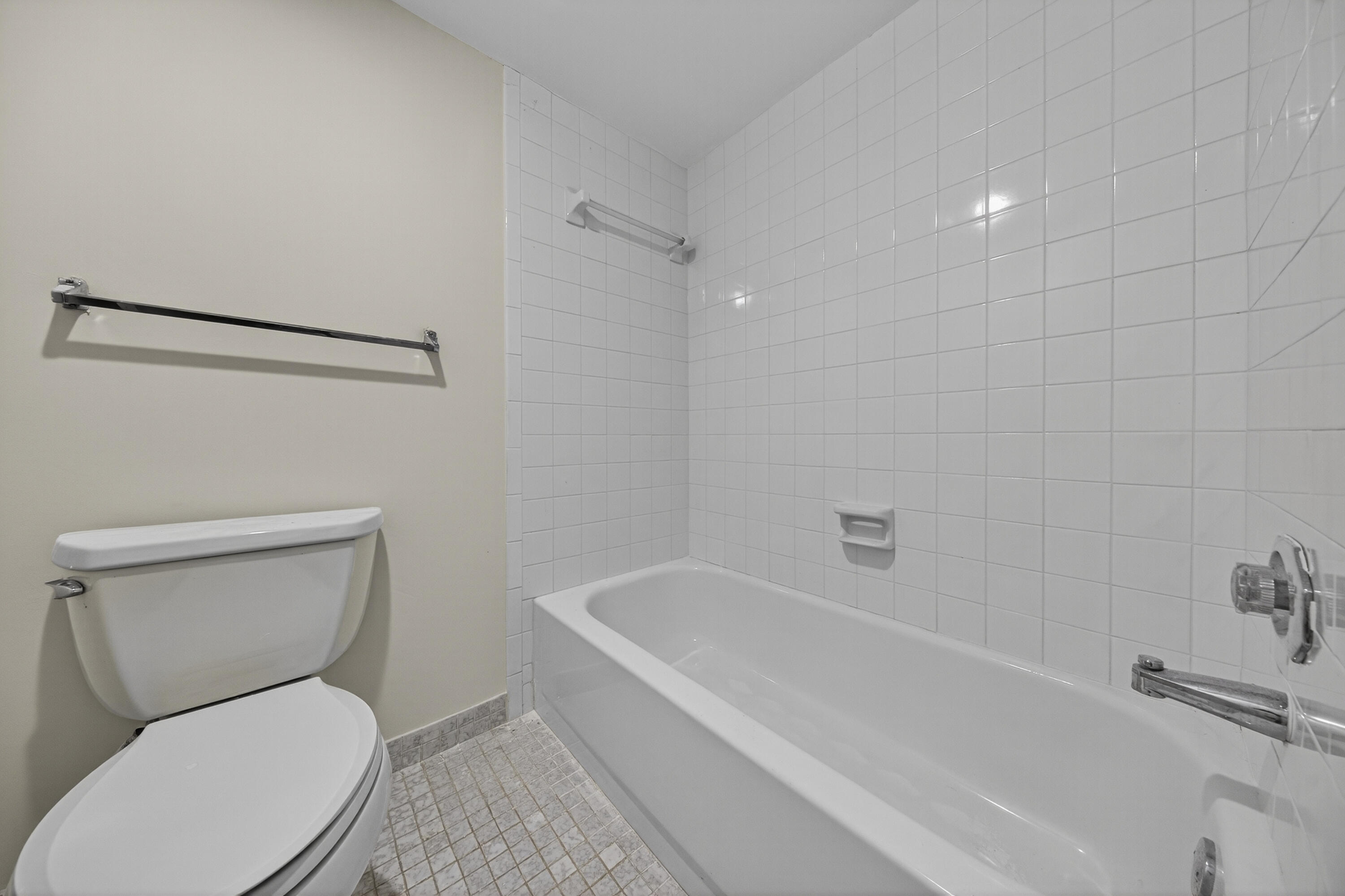 9187 Norte Lago, Unit 5I Boca Raton, FL 33428 - Photo 24 of 37 a white toilet sitting next to a bath tub