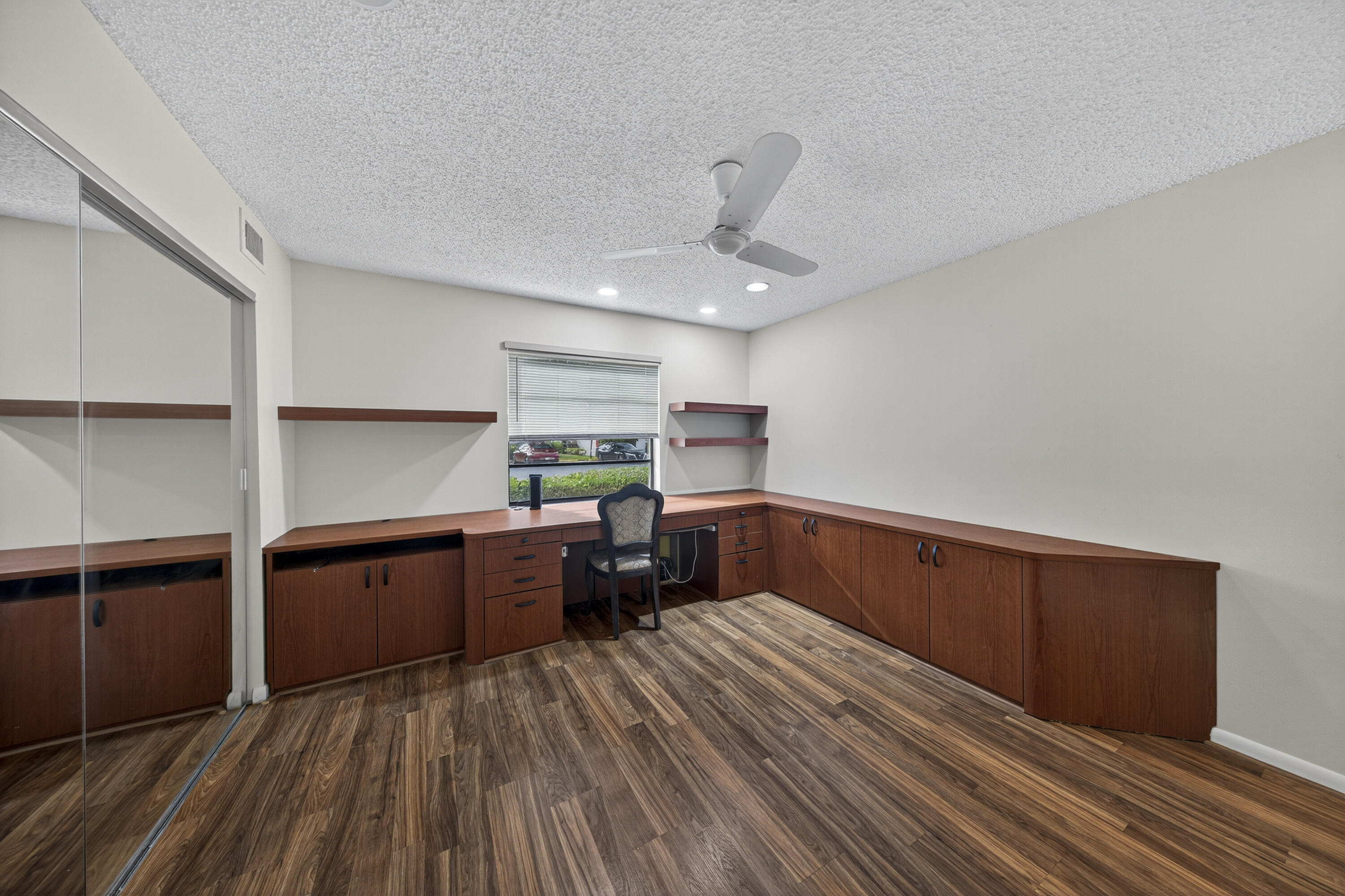 9187 Norte Lago, Unit 5I Boca Raton, FL 33428 - Photo 26 of 37 a kitchen with stainless steel appliances granite countertop a refrigerator a sink dishwasher a stove and white countertops with wooden floor
