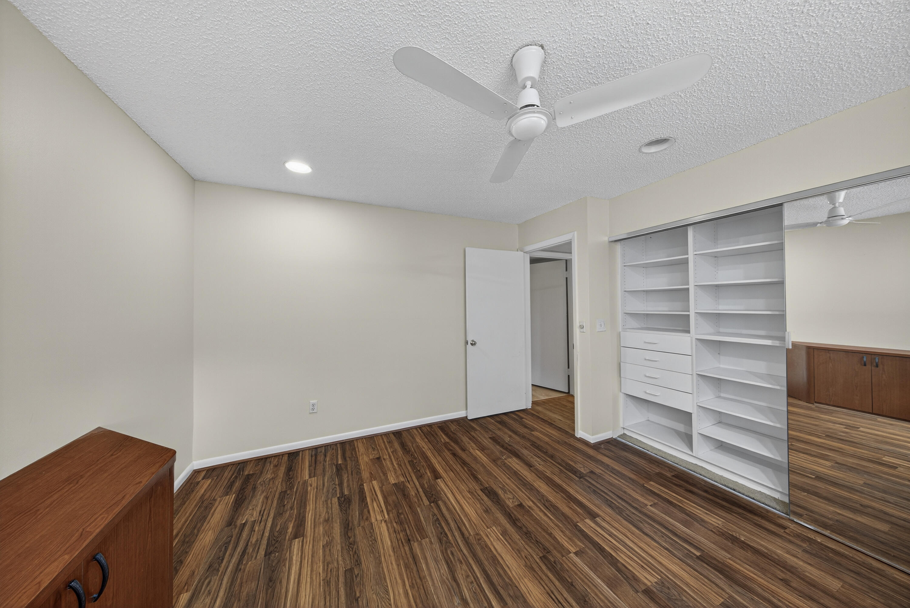 9187 Norte Lago, Unit 5I Boca Raton, FL 33428 - Photo 27 of 37 wooden floor in an empty room