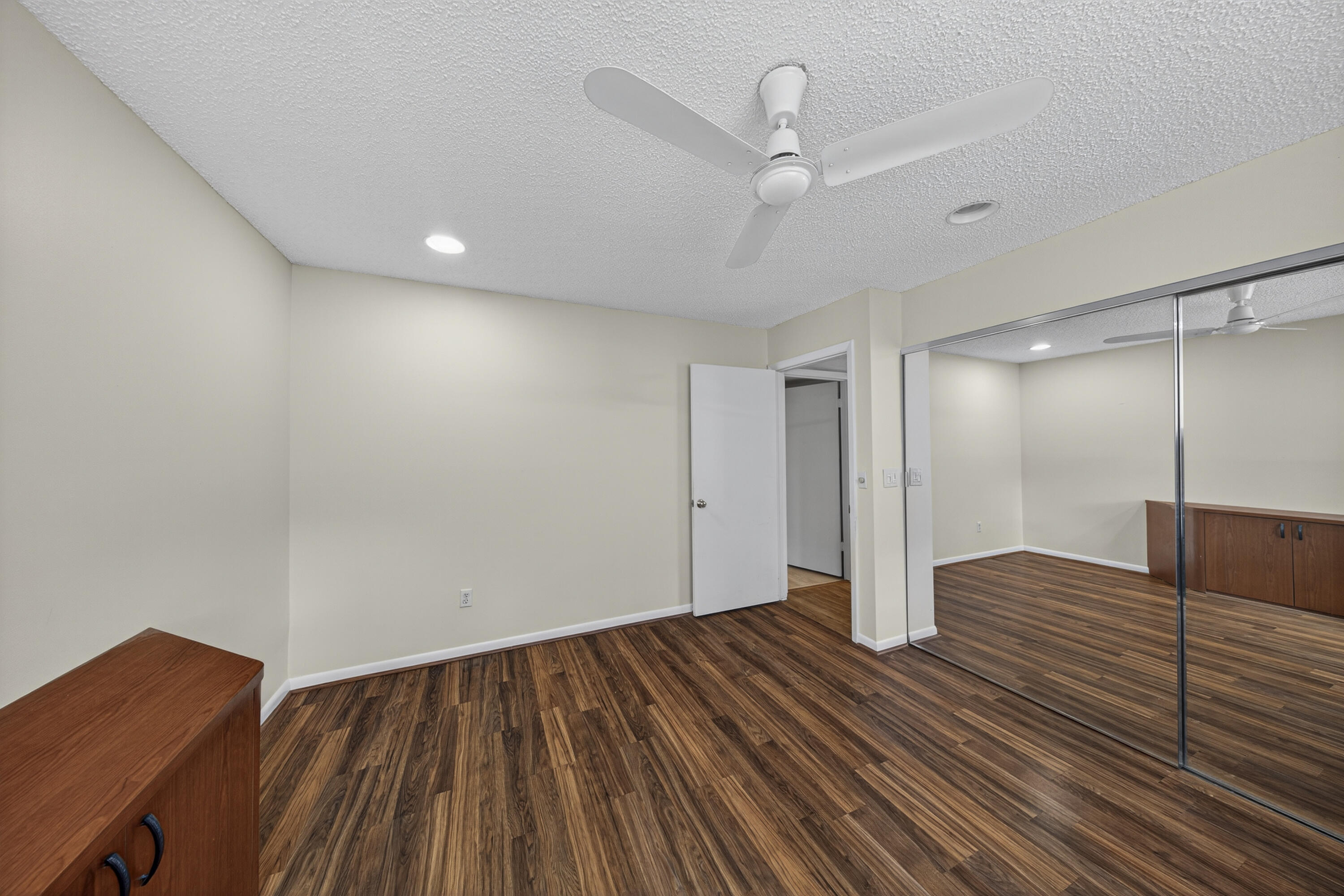 9187 Norte Lago, Unit 5I Boca Raton, FL 33428 - Photo 28 of 37 a view of an empty room with wooden floor