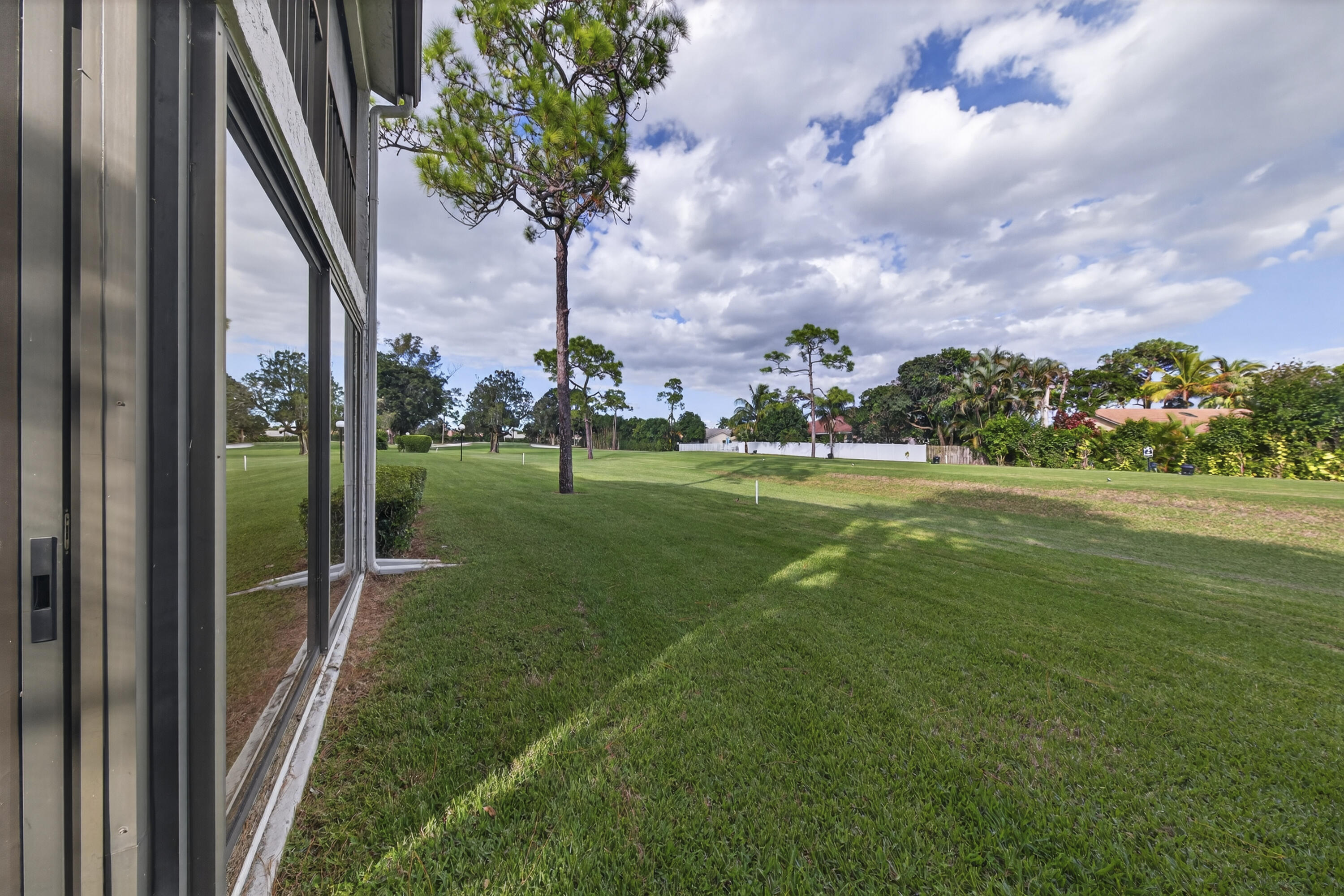 9187 Norte Lago, Unit 5I Boca Raton, FL 33428 - Photo 31 of 37 a view of a park with swings and slides