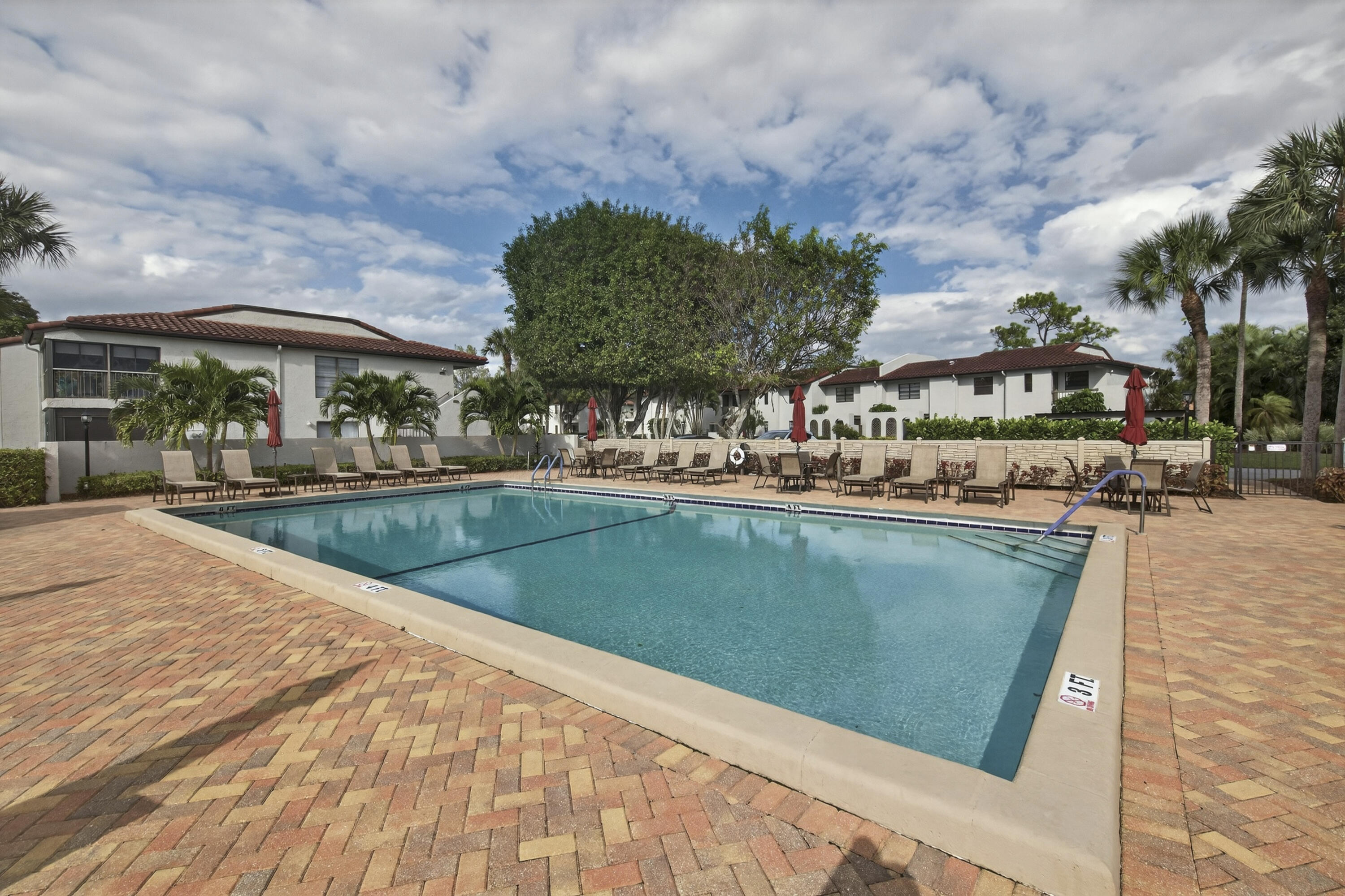 9187 Norte Lago, Unit 5I Boca Raton, FL 33428 - Photo 34 of 37 a view of a swimming pool with a patio